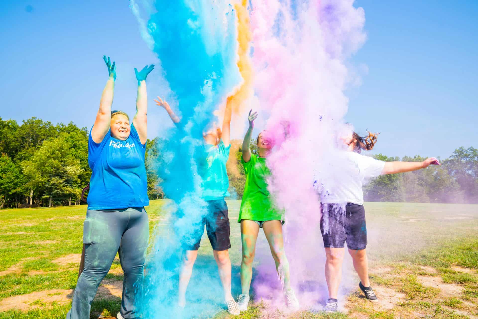 Girl scouts throwing up colored powder